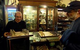 Imad Khachan shows a customer chess set. Sets range from $10 to $10,000. Photo credit: Russ Marhull